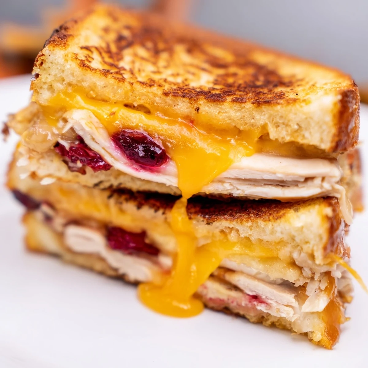 Smoked Turkey Grilled Cheese on golden toasted sourdough, featuring melted sharp cheddar and a tangy cranberry spread.