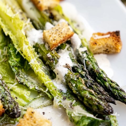 Golden-roasted asparagus spears glisten over crisp romaine in this fresh Roasted Asparagus Caesar Salad, topped with crunchy homemade croutons.