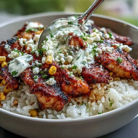 Sizzling citrus-marinated chicken thighs and fluffy rice topped with charred corn for Street Corn Chicken and Rice Bowls.