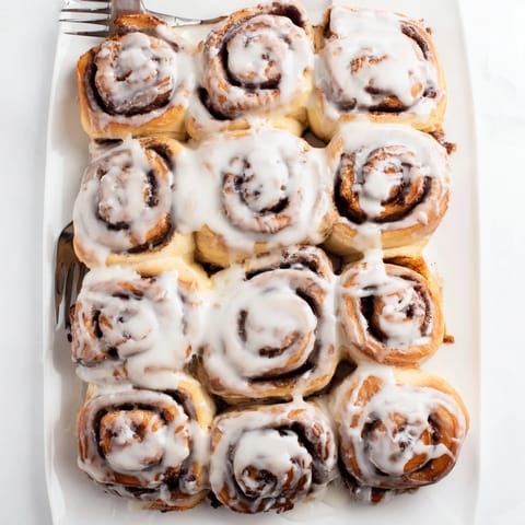 Warm spiraled Cinnamon Rolls with a sweet cinnamon sugar filling, perfect for brunch with family and friends.