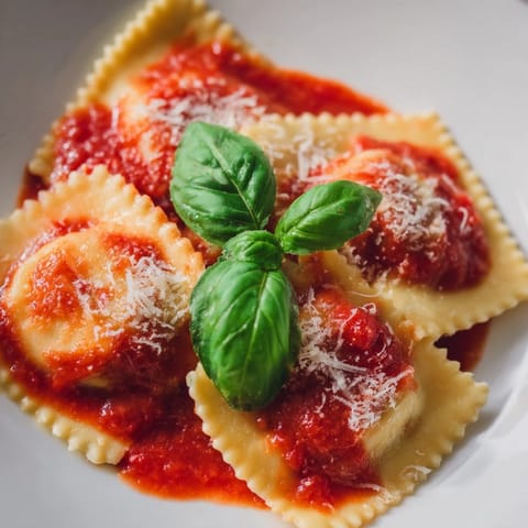 Tender homemade ravioli stuffed with ricotta and spinach served in rich marinara sauce.