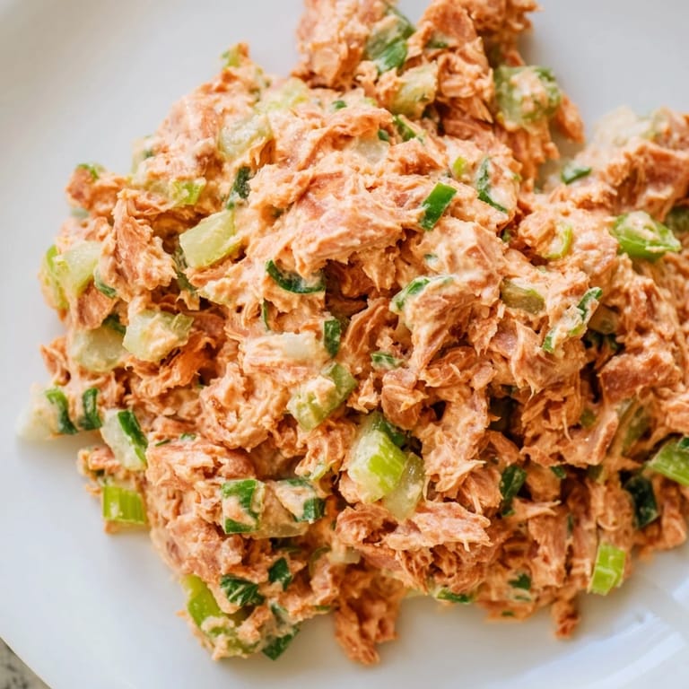 Zesty tuna salad mixed with Sriracha mayo and lemon, garnished with parsley for a refreshing protein boost.