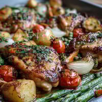 Healthy Easy Sheet Pan Chicken with Spring Veggies, roasted to golden perfection with asparagus, tomatoes, and bell peppers.