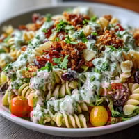 Vibrant taco pasta salad with colorful veggies, creamy dressing, and tortilla chips, perfect for summer potlucks and easy entertaining.